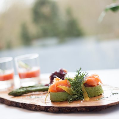 Snack with smoked salmon on wood board Restaurant Rotisserie Hotel des Nordens